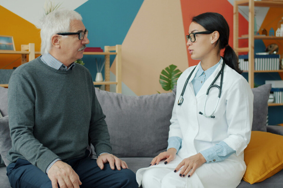 Doctor reviewing leg artery treatment options for peripheral artery disease with a patient