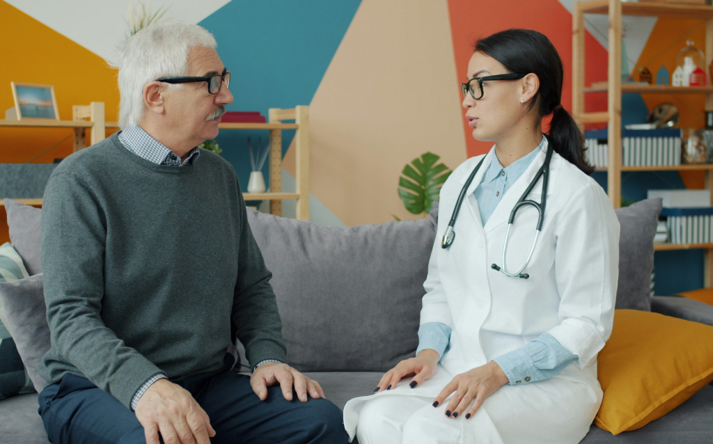 Doctor reviewing leg artery treatment options for peripheral artery disease with a patient