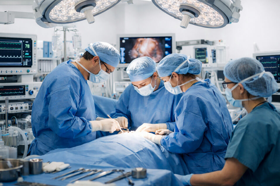 Cath lab medical team preparing cardiovascular equipment for a procedure